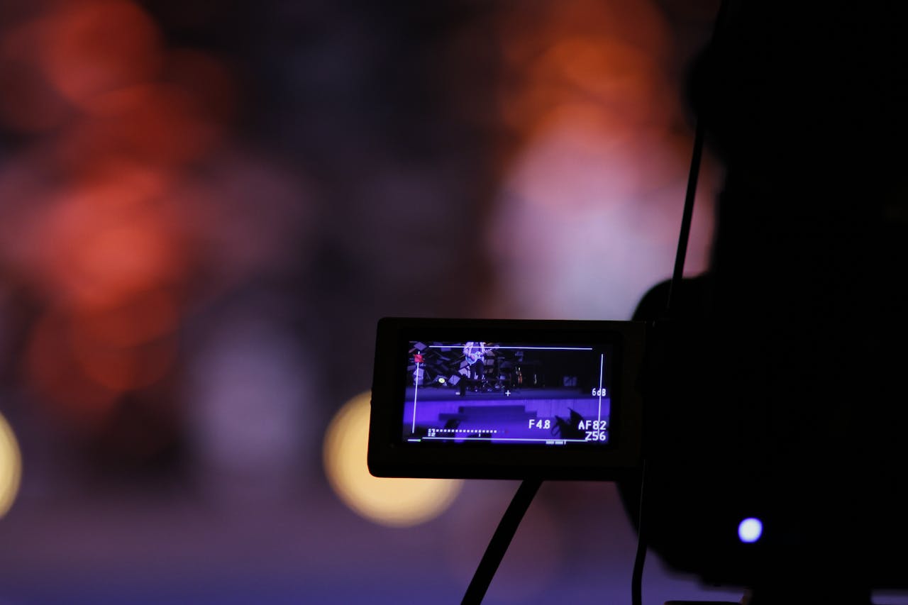 services-02 Close-up of a digital camera screen recording a scene with a vibrant bokeh background.